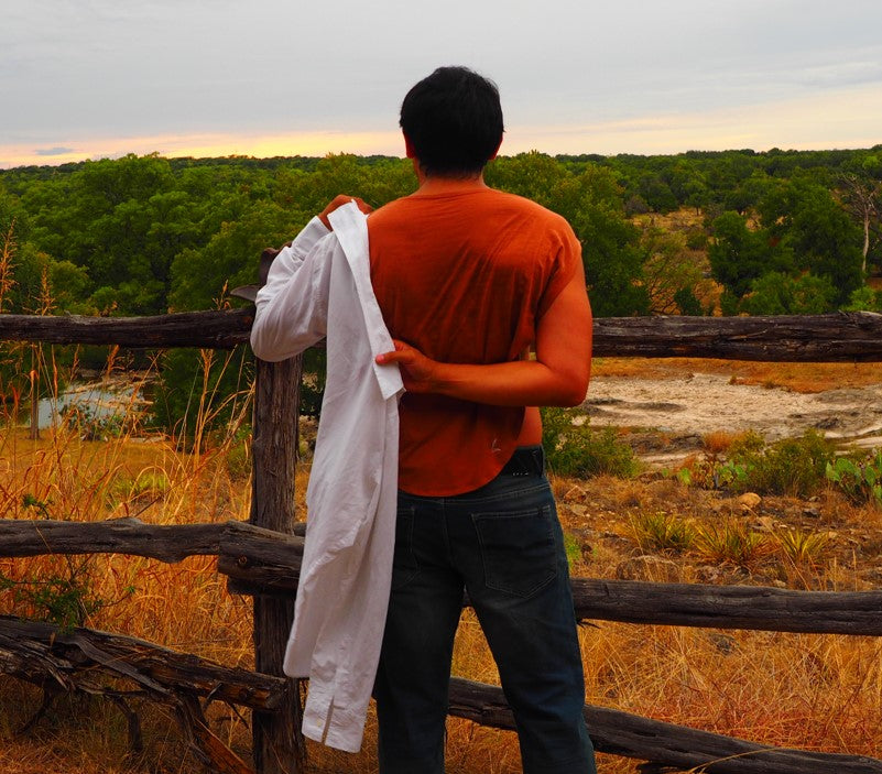 Putting on a dress shirt of the  LESPIRANT LCut undershirt at a ranch in Texas